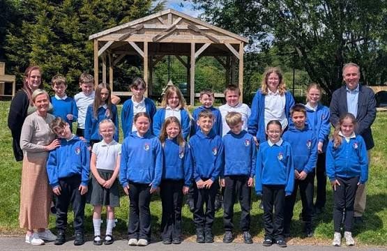 Pupils and staff by the outdoor classroom